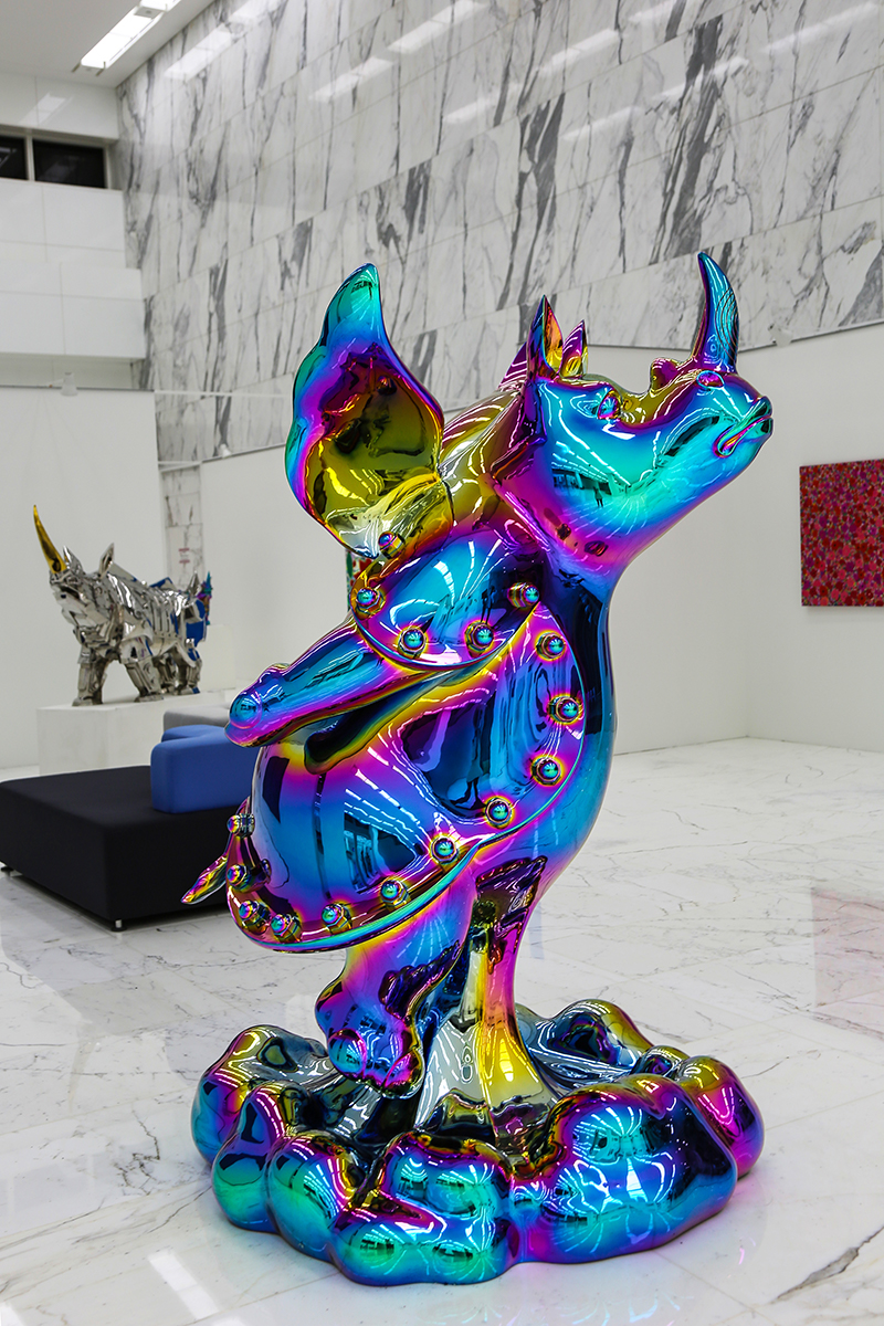 Shih Li-Jen's Skyrocket sculpture in HTC Gallery, a colorful titanium-coated cartoon rhino ascending skyward